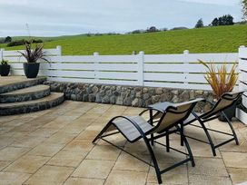 An outdoor area with lounge chairs and plants at O7 in Abersoch