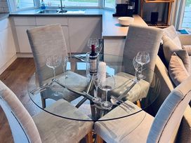 A dining room with a glass table and chairs at O7 in Abersoch