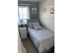 A bedroom with a bed and bedside table at O7 in Abersoch
