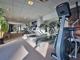 A gym with elliptical machines and plants at O7 Abersoch