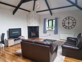 A living room with a sofa, coffee table, and TV at the property