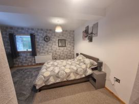 A bedroom with a bed and bedside table at The Old Barn in Manchester