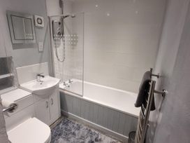 A bathroom with bathtub, shower, sink, and toilet at The Old Barn in Manchester