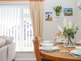 A dining area with a table set for a meal at Halsdon Avenue in Exmouth