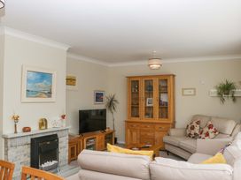 A living room with a sofa and television at Halsdon Avenue in Exmouth