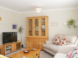 A living room with a television and a coffee table at Halsdon Avenue in Exmouth