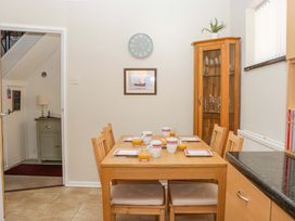 A dining room with a table set for breakfast at Halsdon Avenue in Exmouth