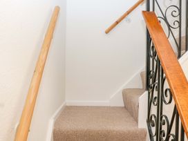 A staircase with carpeted steps and handrails at Halsdon Avenue in Exmouth
