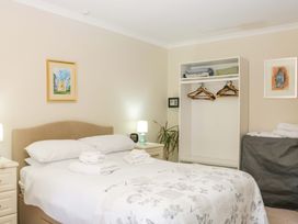 A bedroom with a bed and wardrobe at Halsdon Avenue Exmouth