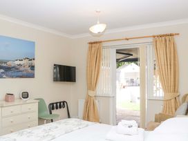 A bedroom with a bed and TV at Halsdon Avenue Exmouth