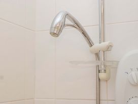 A showerhead and control unit in a bathroom at Halsdon Avenue Exmouth