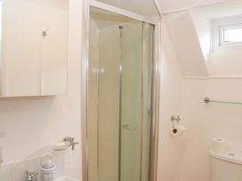 A bathroom featuring a shower, sink, and toilet at Halsdon Avenue in Exmouth