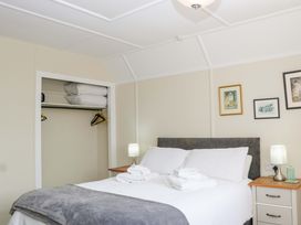 A bedroom with a bed and closet at Halsdon Avenue, Exmouth