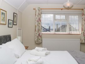 A bedroom with a bed and window at Halsdon Avenue in Exmouth
