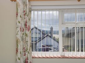 A window with a view of houses and landscape at Halsdon Avenue in Exmouth