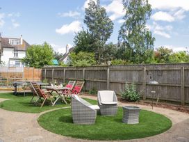 A garden with seating and dining table at Halsdon Avenue in Exmouth