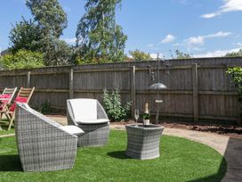A garden with chairs and a table in Halsdon Avenue Exmouth