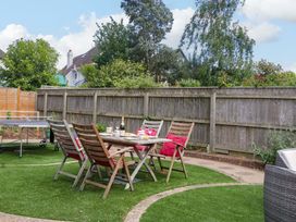 A garden with a table and chairs and a ping pong table at Halsdon Avenue, Exmouth