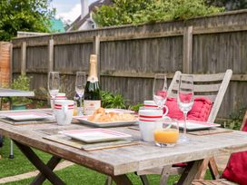 A garden table set for breakfast with drinks and pastries at Halsdon Avenue in Exmouth