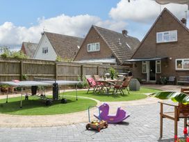 A garden with a ping pong table and seating area at Halsdon Avenue, Exmouth