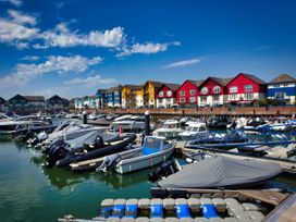 A marina with boats and residential buildings at Halsdon Avenue in Exmouth