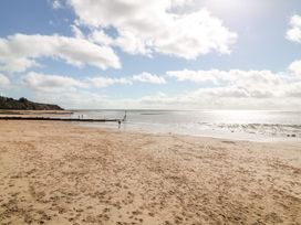 A beach with sand and water at Halsdon Avenue in Exmouth