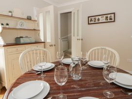 A dining room with a table set for six at Arosfa in New Quay
