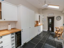 A kitchen with cabinets and a countertop at Arosfa in New Quay
