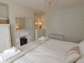 A bedroom with a bed and furniture at Arosfa New Quay