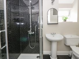 A bathroom with a shower, sink, and toilet at Arosfa New Quay