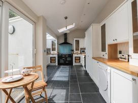 A kitchen with cabinets and appliances at Arosfa in New Quay