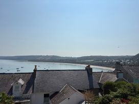 A view of the sea and beach with boats at Arosfa New Quay