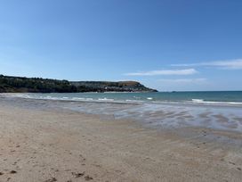 A beach with sand and water at Arosfa New Quay