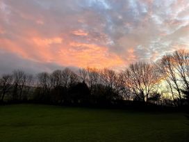 A landscape view with trees and a colorful sky at The White House Okehampton