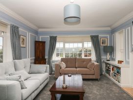 A living room with a sofa and window at The White House in Okehampton