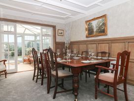 A dining room with a table set for dinner at The White House in Okehampton