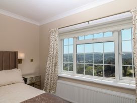 A bedroom with a window showing a view at The White House in Okehampton