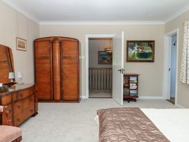 A bedroom with a wardrobe and dressing table at The White House in Okehampton