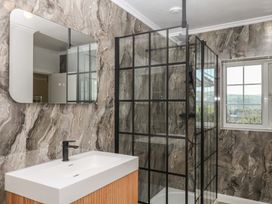 A bathroom with a sink and shower at The White House in Okehampton