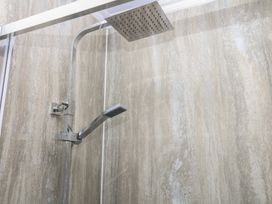 A shower installation with a shower head and handle at The White House in Okehampton