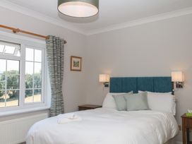 A bedroom with a bed and window at The White House in Okehampton