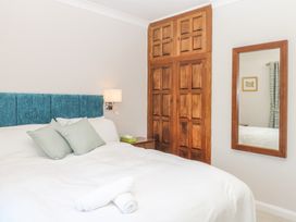 A bedroom with a bed and wardrobe at The White House in Okehampton