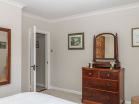 A bedroom with a dresser and mirror at The White House Okehampton