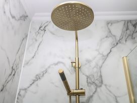 A shower head and fixtures in a bathroom at The White House in Okehampton