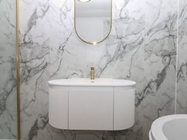 A bathroom with a vanity and a mirror at The White House in Okehampton