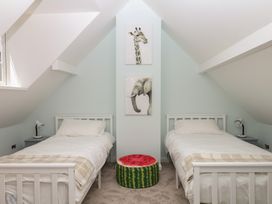 A bedroom with two beds and animal artwork at The White House in Okehampton