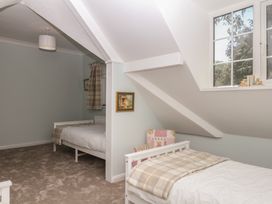 A bedroom with two beds and a window at The White House in Okehampton