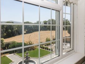 A view from a window showing a garden and fields at The White House in Okehampton