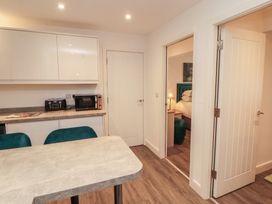 A kitchen with appliances and dining table at Hidden Gem 