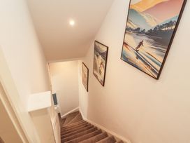 A staircase with framed art on the wall at Hidden Gem